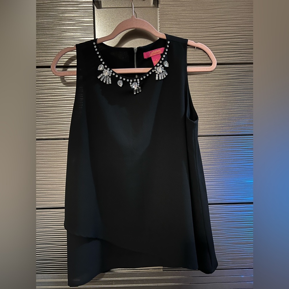Small, black blouse with rhinestone neck detailing. Will fit a medium.